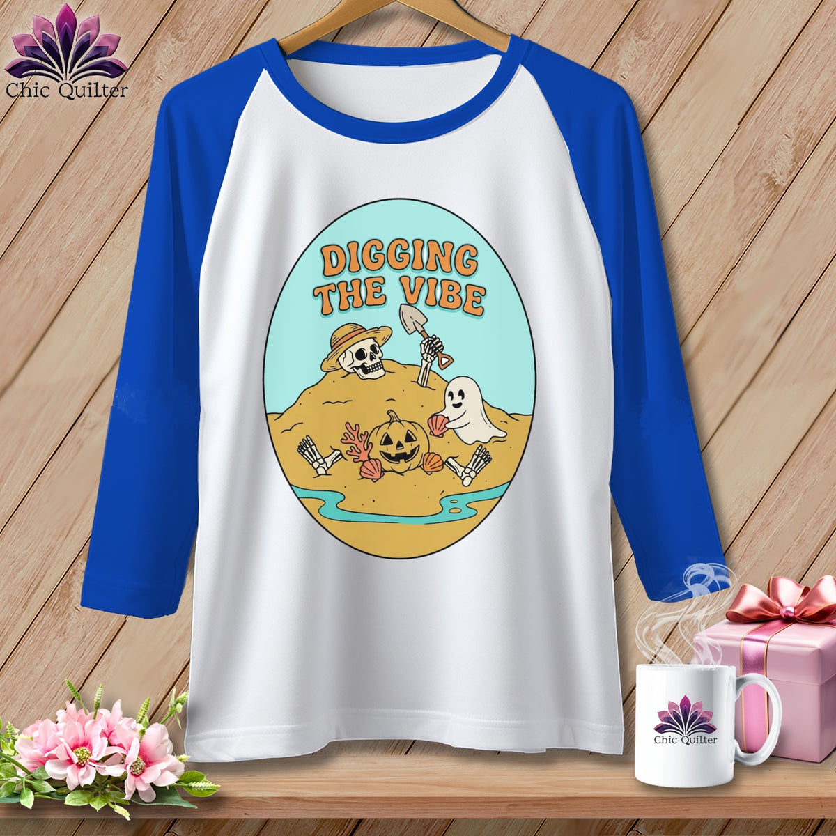White raglan shirt with "Digging the Vibe" Halloween graphic on a beach scene.