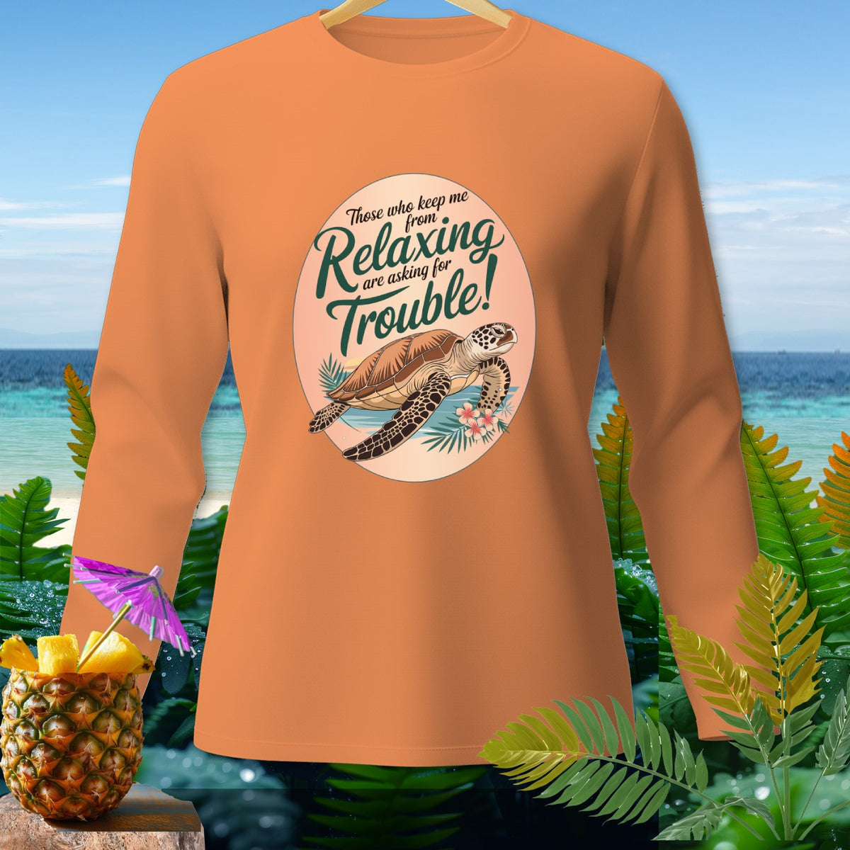 Orange long-sleeve shirt with sea turtle graphic and text "Relaxing are asking for Trouble!".