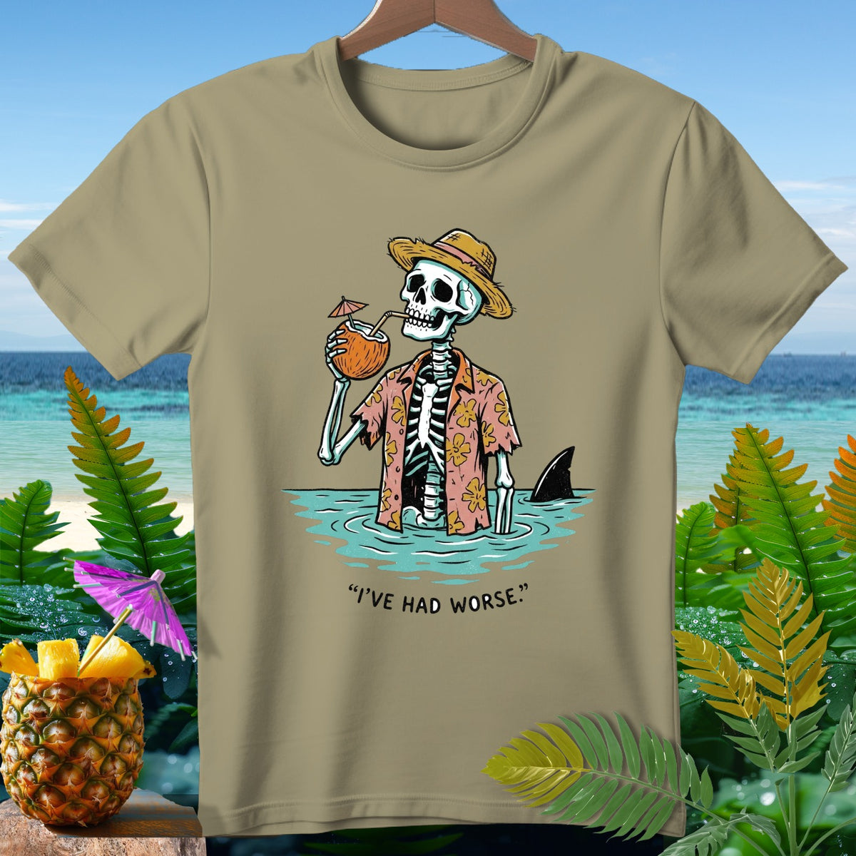 Skeleton in Hawaiian shirt drinks coconut, shark fin behind, with text "I'VE HAD WORSE."
