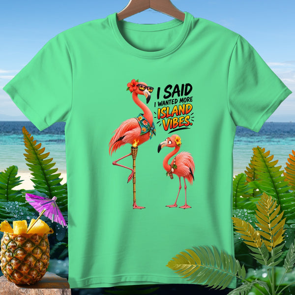 Two flamingos with sunglasses and flowers on a shirt that says "I Said I Wanted More Island Vibes."