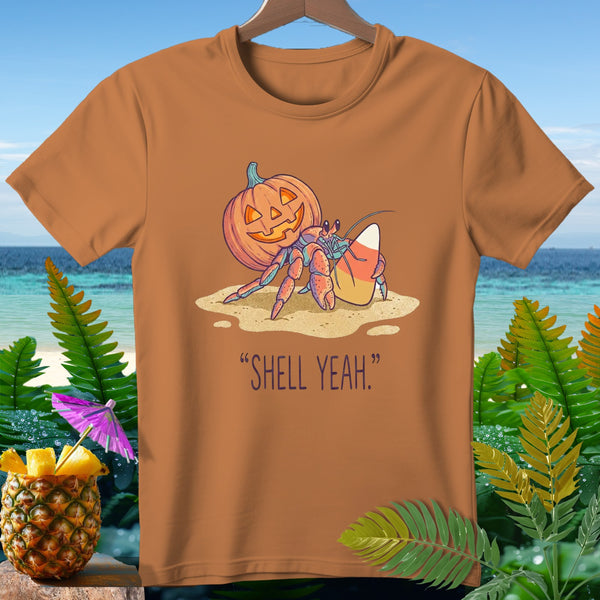 Hermit crab with pumpkin and candy corn on sand, text "SHELL YEAH."