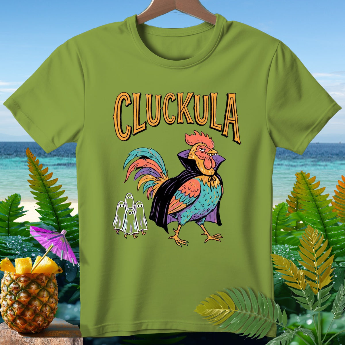 Green t-shirt featuring a rooster dressed as Dracula with "Cluckula" text and small ghosts.