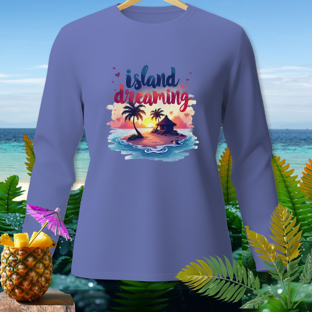 Purple long sleeve shirt with "island dreaming" graphic of a tropical island at sunset.