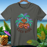 T-shirt with three carved coconut faces and palm fronds, saying 