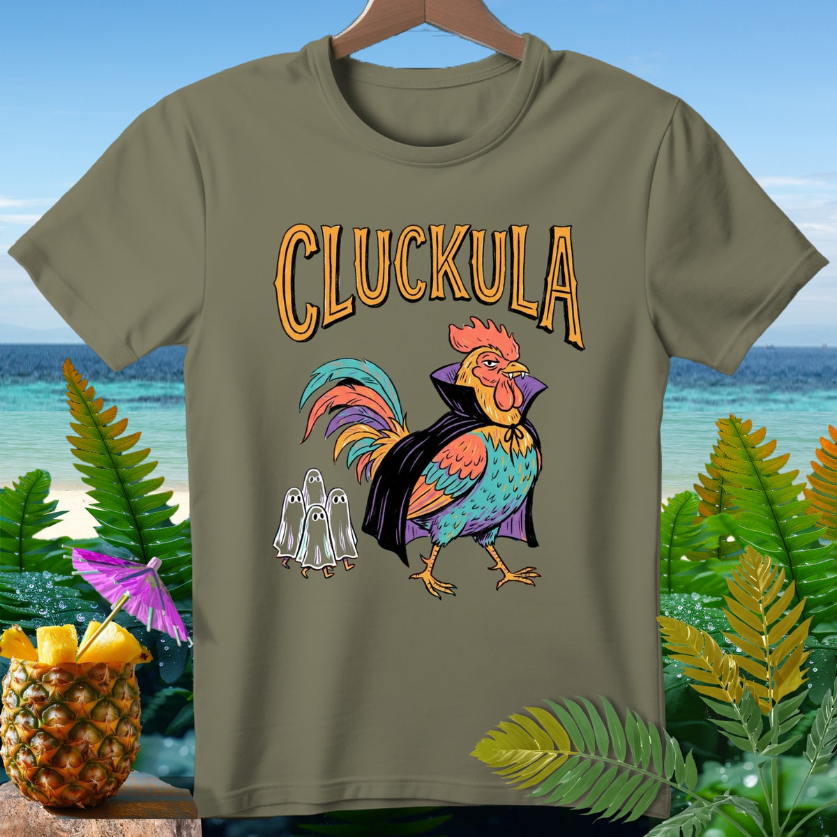 Olive t-shirt with a Halloween-themed "Cluckula" rooster and ghosts graphic.
