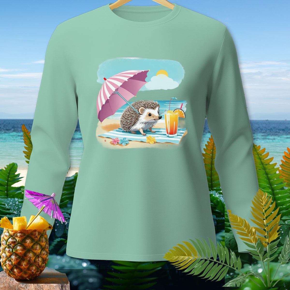 Mint green long-sleeve shirt with a beach scene featuring a hedgehog under an umbrella.