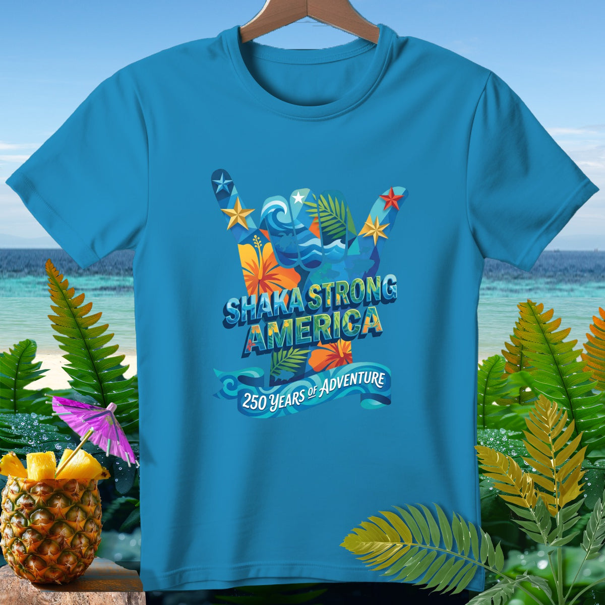 Blue t-shirt with "Shaka Strong America 250 Years of Adventure" graphic.
