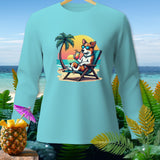 Light blue long-sleeve shirt with cartoon dog in sunglasses on a beach lounge chair.