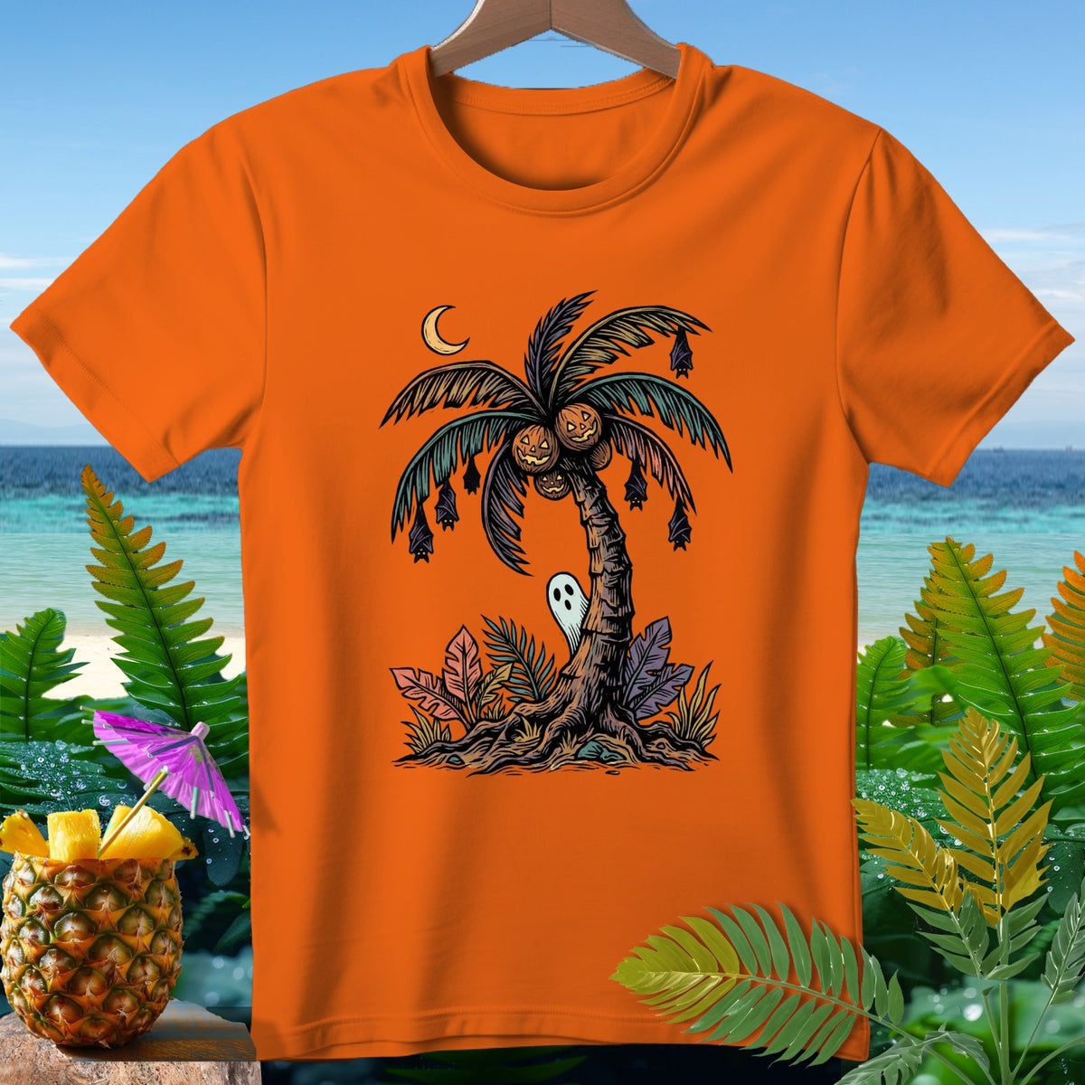Orange t-shirt with a Halloween palm tree graphic featuring pumpkins, bats, and a ghost.