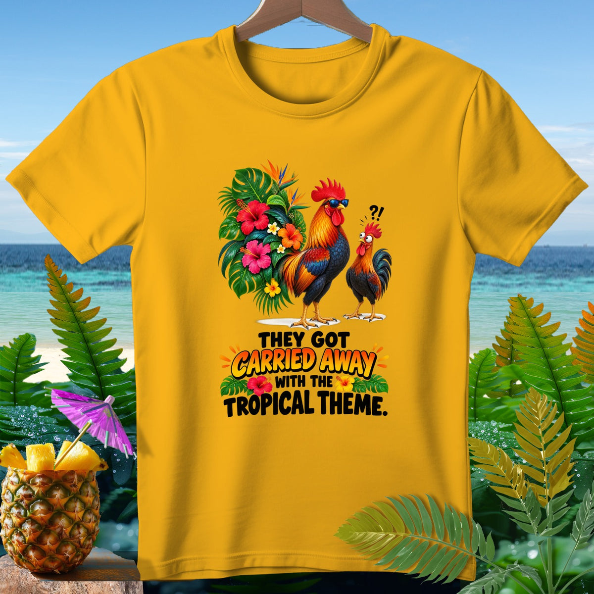 Yellow t-shirt with roosters and tropical flowers, text "THEY GOT CARRIED AWAY WITH THE TROPICAL THEME."
