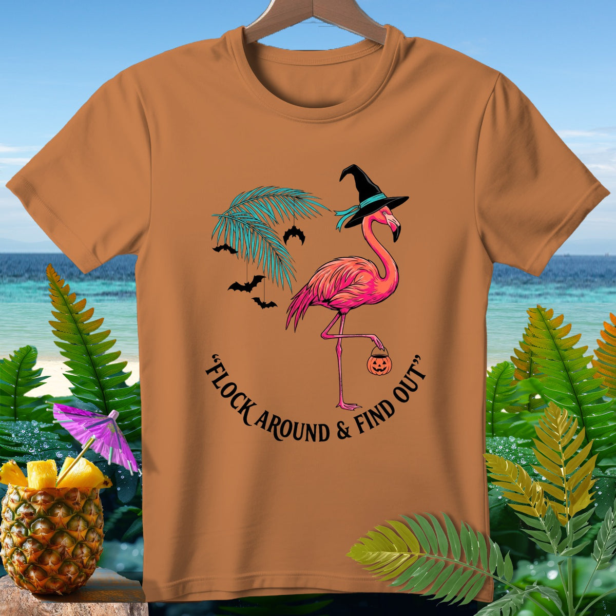 Orange t-shirt with flamingo in witch hat and "Flock Around & Find Out" text.