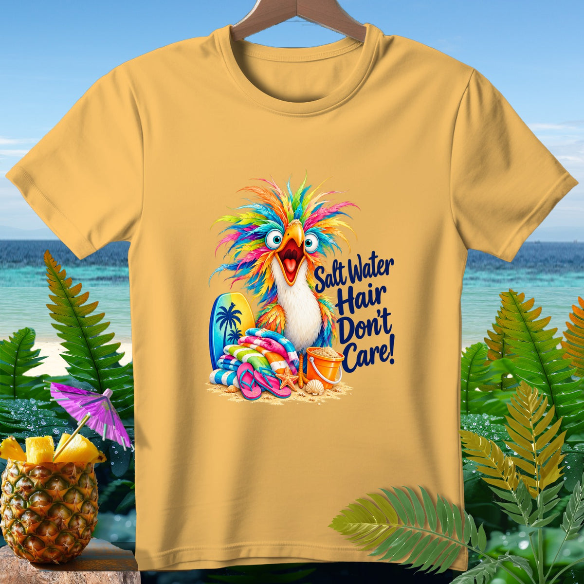 Yellow t-shirt with a colorful parrot, surfboard, towels, and the text "Salt Water Hair Don't Care!".