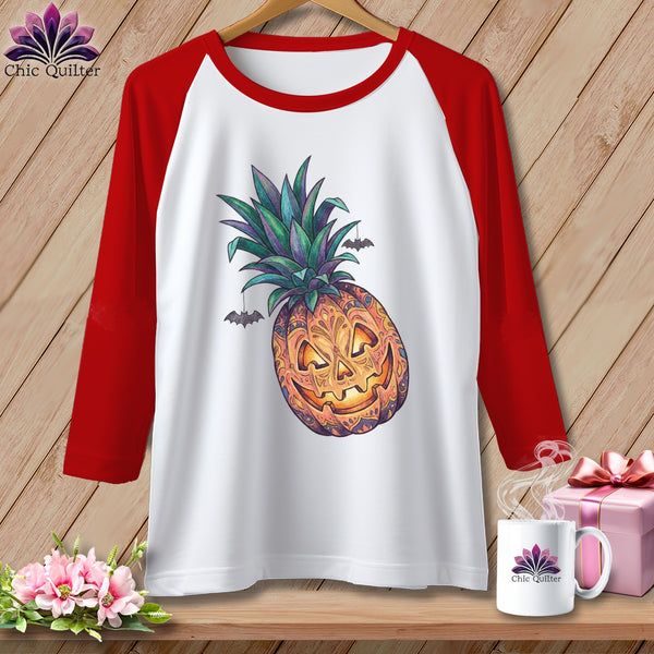 Raglan t-shirt with jack-o'-lantern pineapple and bat design.