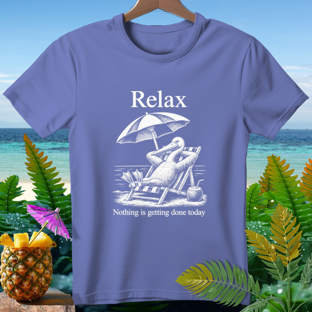 Purple t-shirt with white graphic of a pelican relaxing on a beach chair, reading "Relax. Nothing is getting done today."