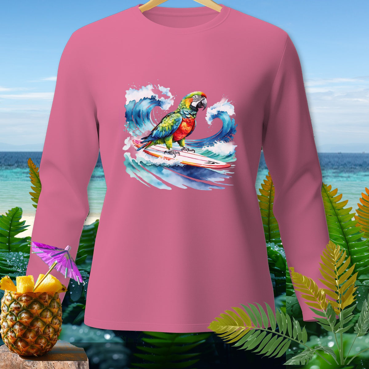 Pink long-sleeve shirt with watercolor graphic of parrot surfing a wave.