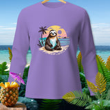 Lavender long-sleeve shirt with a smiling sloth on a beach with palm trees and sunset graphic.