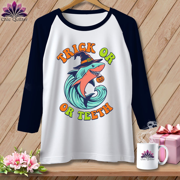 White baseball tee with "Trick Or Teeth" shark graphic and Halloween witch hat.