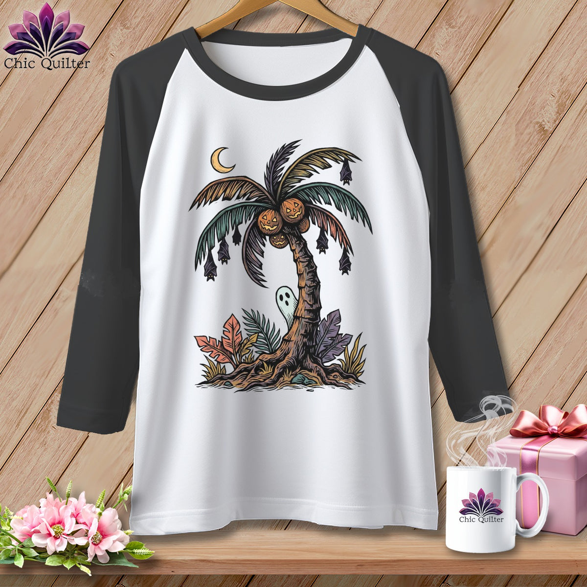 White t-shirt with graphic of a palm tree with pumpkins, bats, and a ghost.