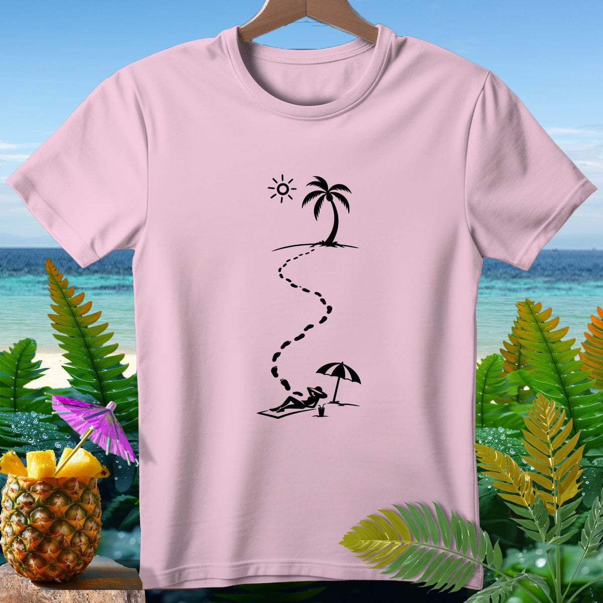 Pink t-shirt with black graphic of footprints leading from a palm tree to a person sunbathing.