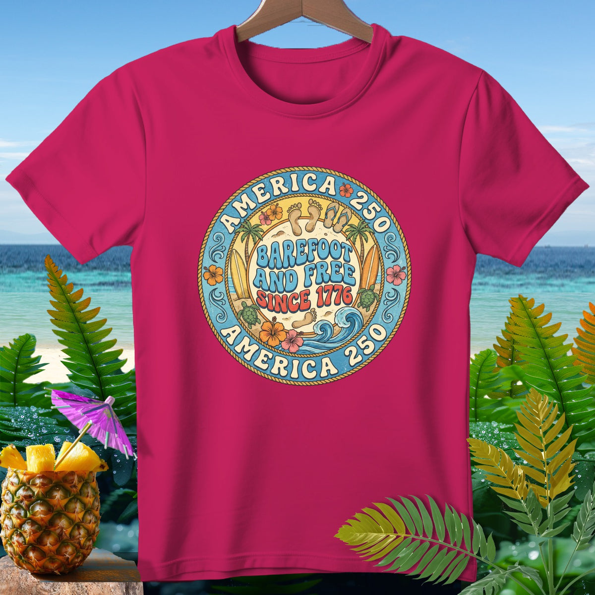 Pink t-shirt with "America 250 Barefoot and Free Since 1776" graphic.