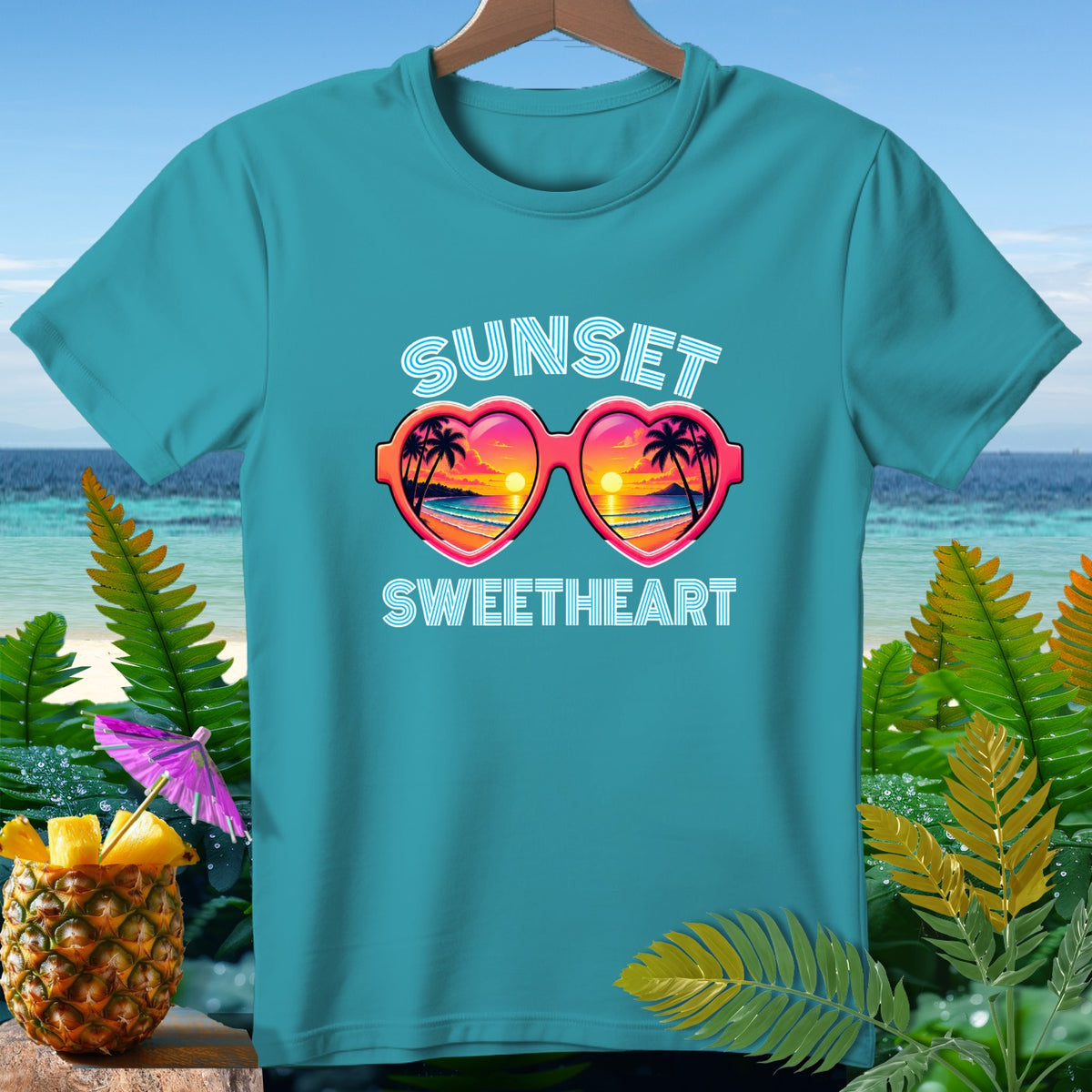 Teal t-shirt with "SUNSET SWEETHEART" and heart-shaped sunglasses graphic.