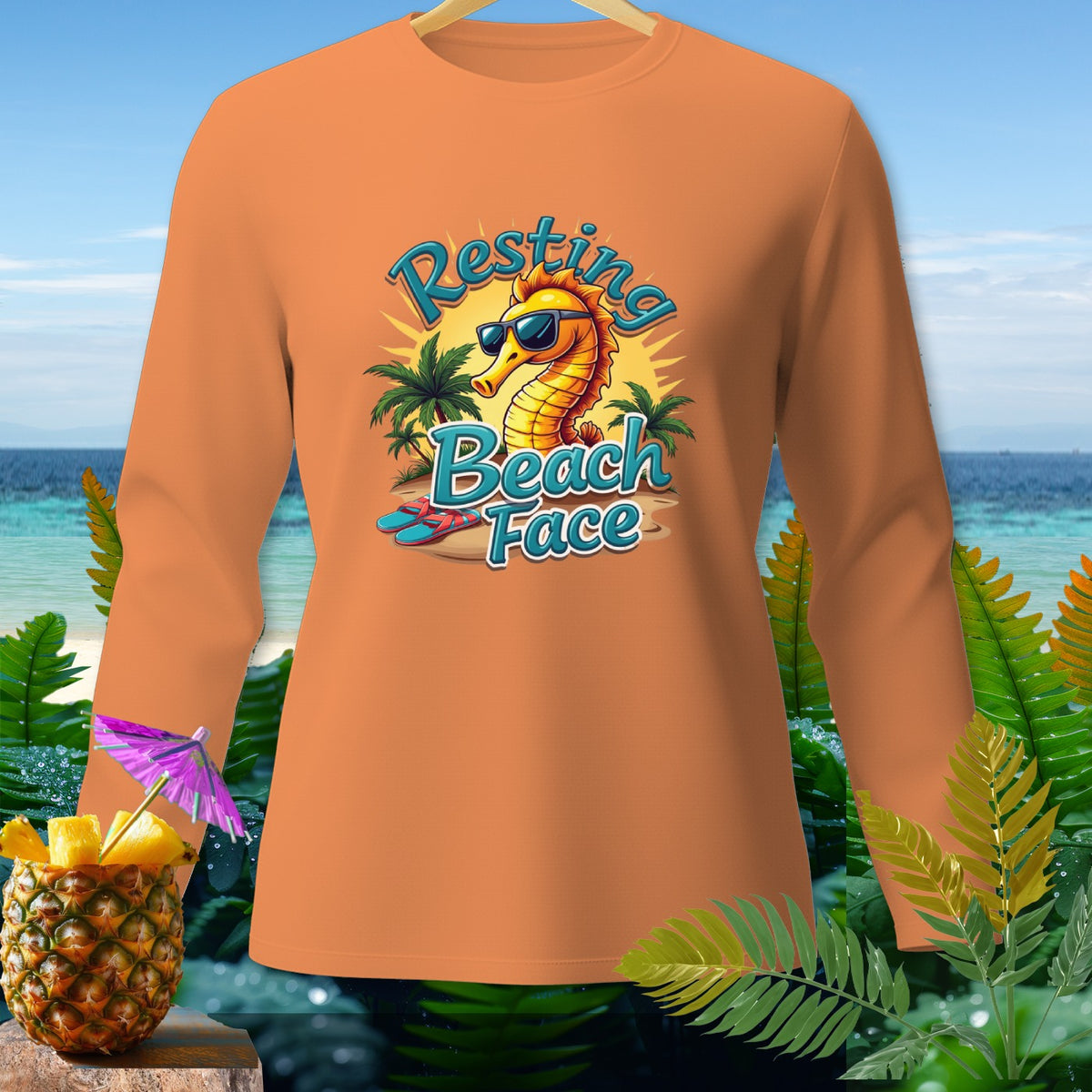Orange long-sleeve shirt with a cartoon seahorse wearing sunglasses and text "Resting Beach Face."