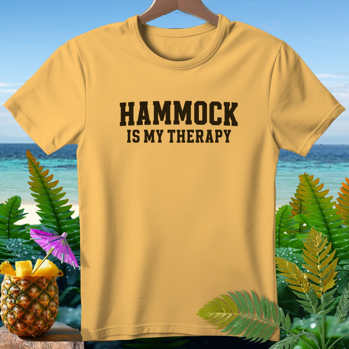 Yellow t-shirt with "HAMMOCK IS MY THERAPY" text, tropical background.
