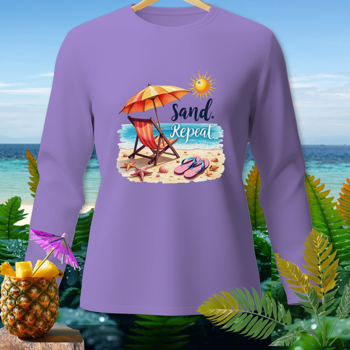Purple long sleeve shirt with beach graphic and "Sand. Repeat." text.
