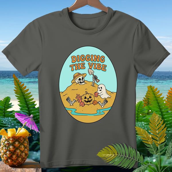 T-shirt with "Digging the Vibe" text, skeleton, ghost, and pumpkin on a beach.