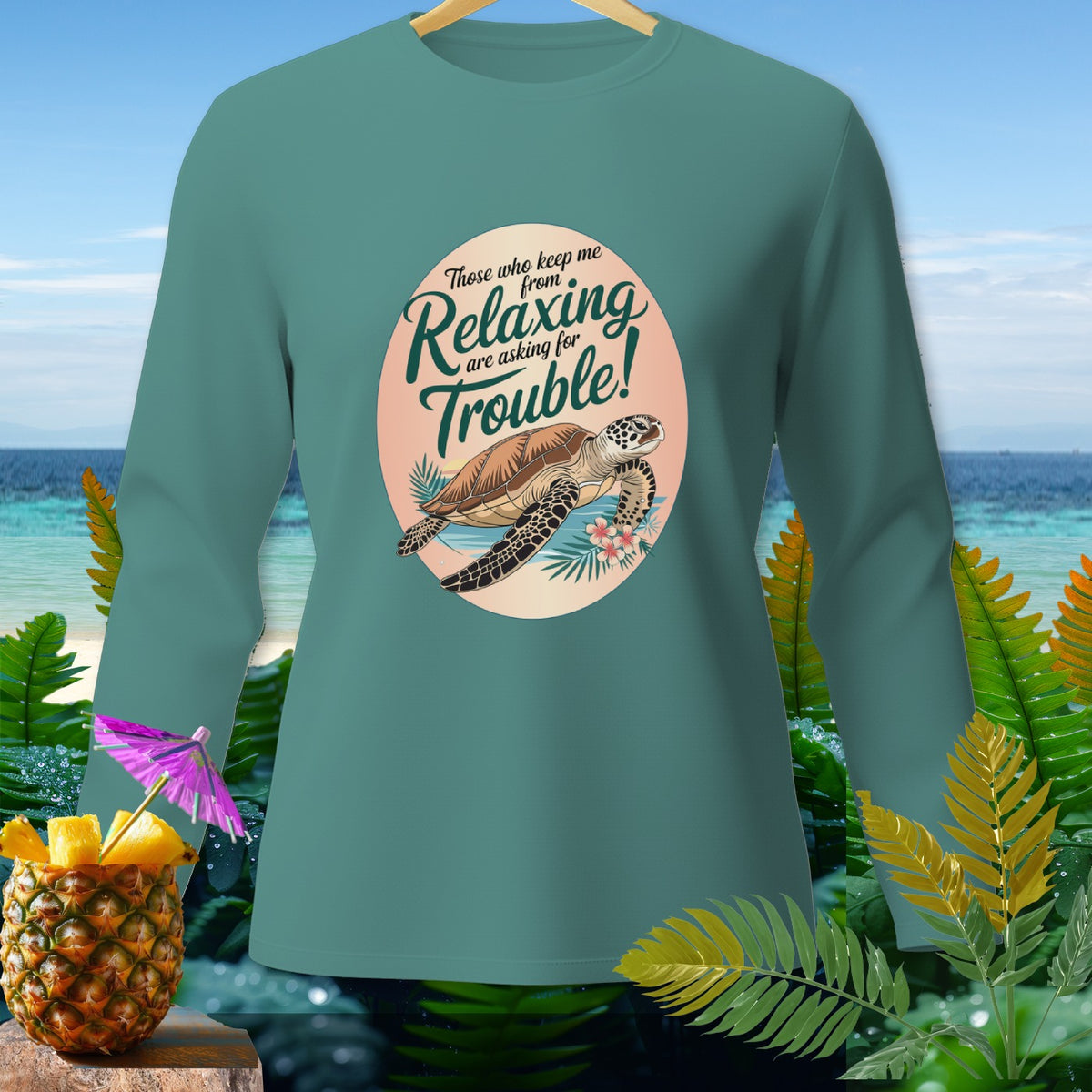 Teal long-sleeve shirt with a graphic of a sea turtle and the text "Those who keep me from relaxing are asking for trouble!"
