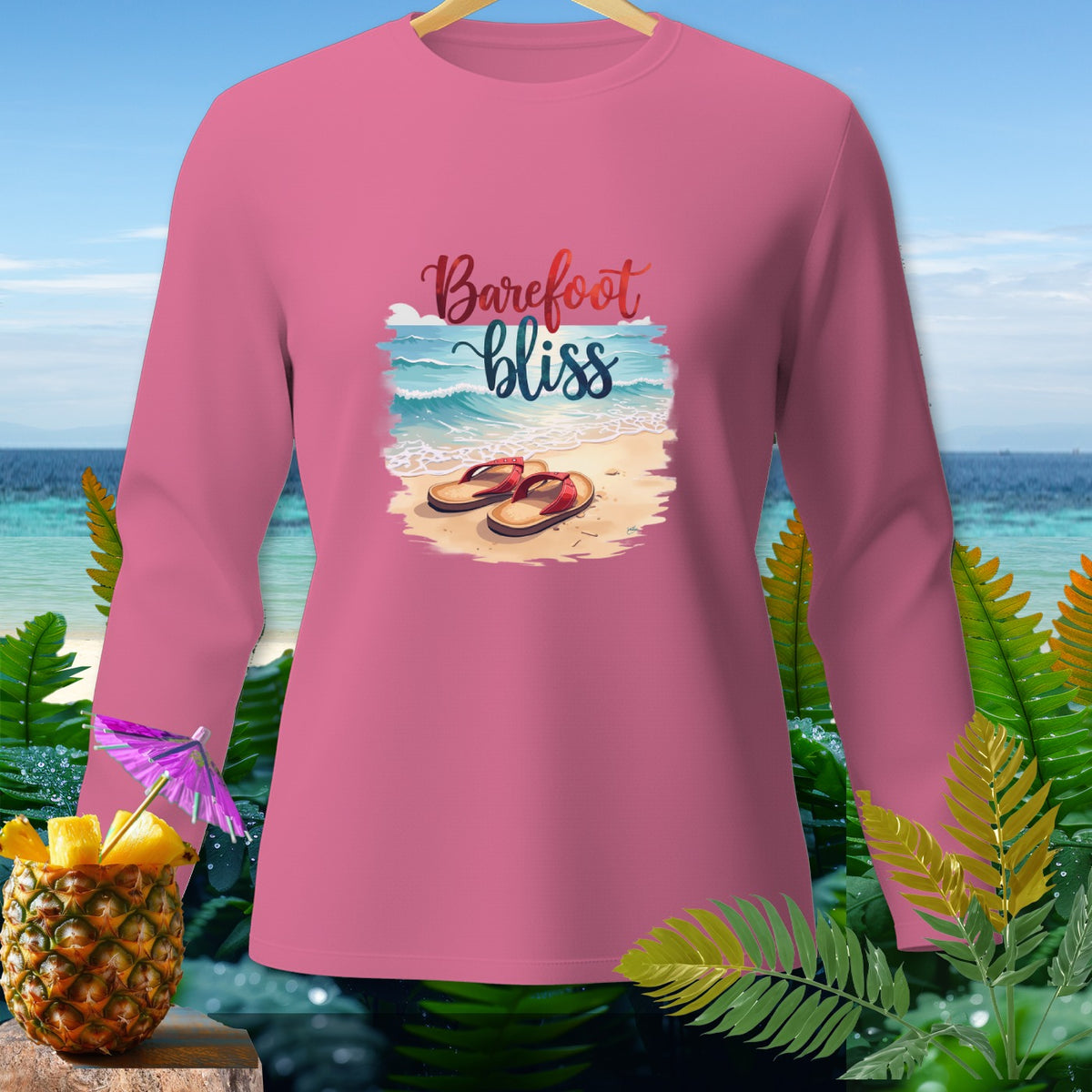 Pink long sleeve shirt with "Barefoot bliss" graphic on a beach scene.