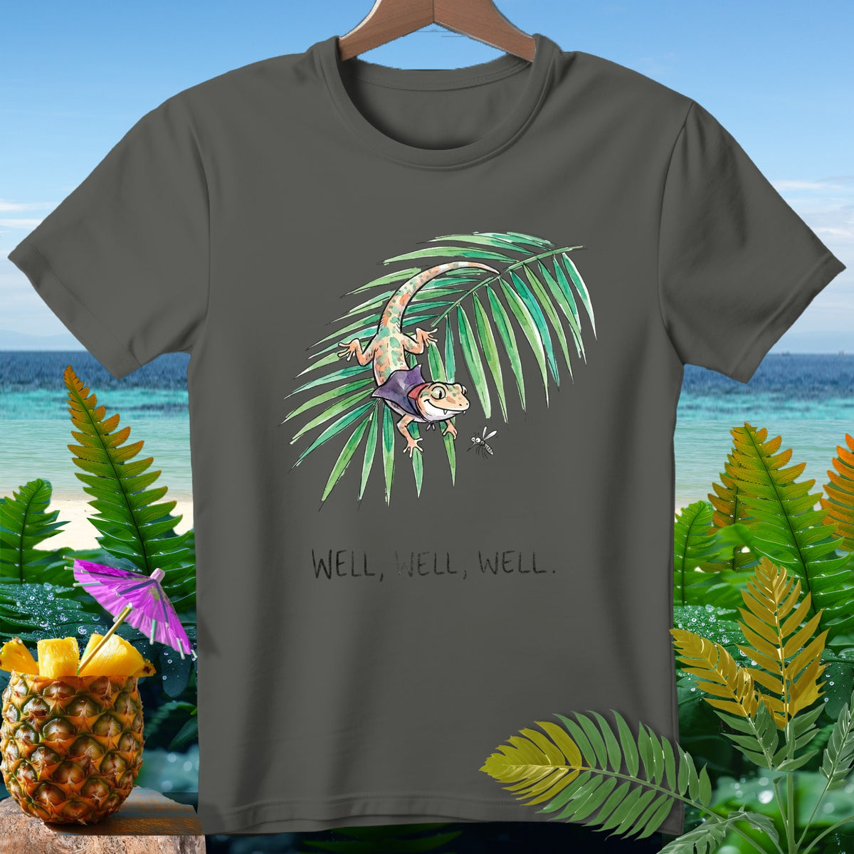 Gray t-shirt with cartoon gecko on palm frond and text "Well, Well, Well."