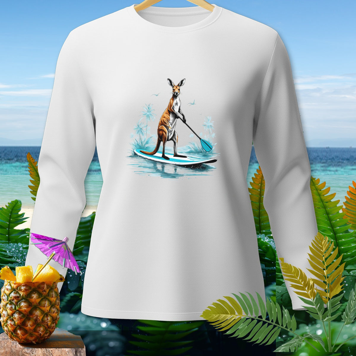 White long-sleeve shirt with graphic of kangaroo paddleboarding on a tropical beach.