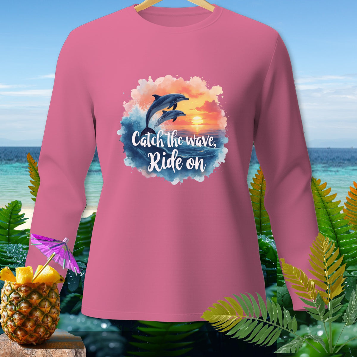 Pink long sleeve shirt with dolphins and "Catch the wave, Ride on" text.