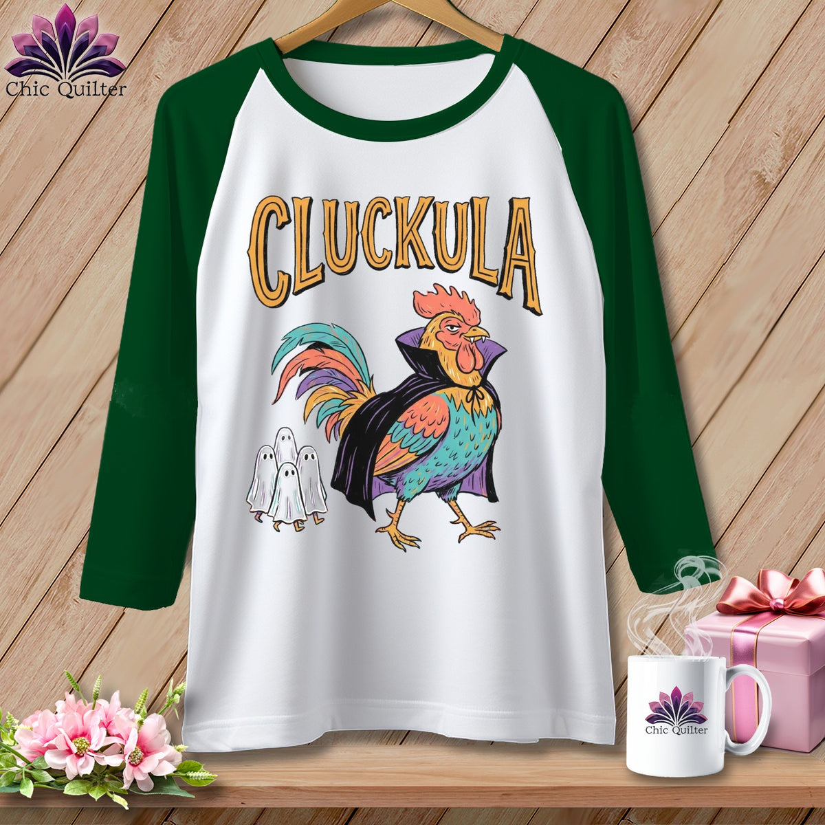 Baseball tee with a rooster in a cape and three ghosts, text "CLUCKULA".