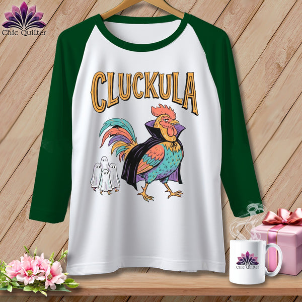 Baseball tee with a rooster in a cape and three ghosts, text "CLUCKULA".