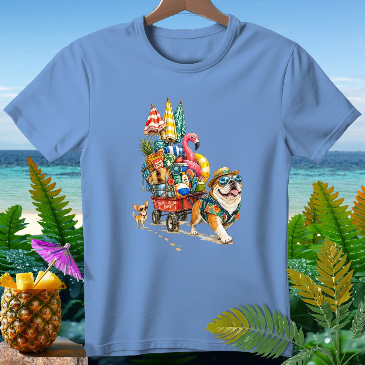 Bulldog and chihuahua pulling a beach wagon filled with vacation items.
