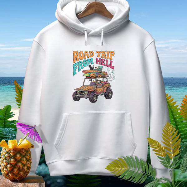 White hoodie with "Road Trip From Hell" text and Halloween-themed graphic on a beach background.