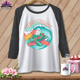 Raglan t-shirt with a graphic of a turtle, ghost, and waves, reading 