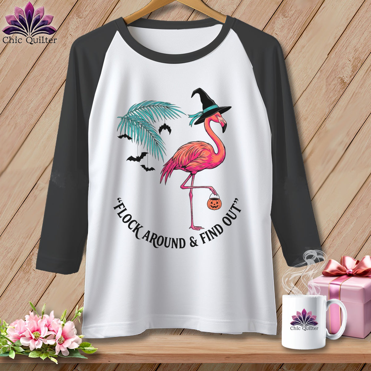 White baseball tee with a pink flamingo wearing a witch hat and holding a pumpkin.