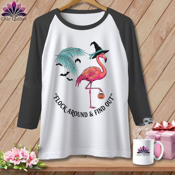 White baseball tee with a pink flamingo wearing a witch hat and holding a pumpkin.