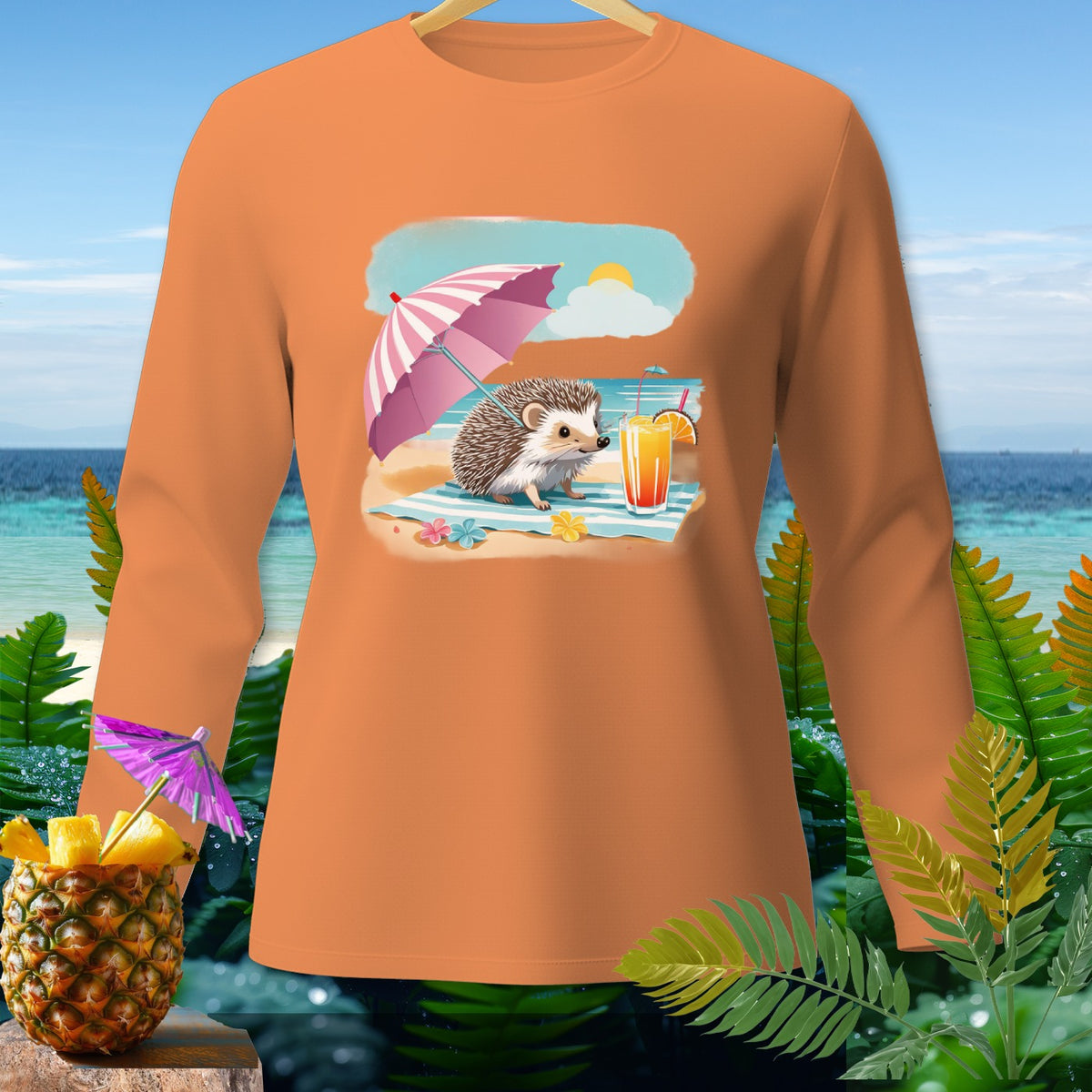 Long sleeve orange shirt with a cartoon hedgehog on a beach under an umbrella.