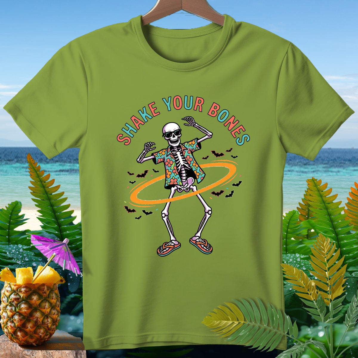 Green t-shirt with a skeleton wearing sunglasses and a Hawaiian shirt, text "SHAKE YOUR BONES".