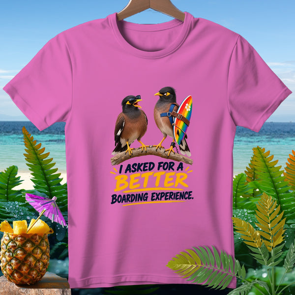 Pink t-shirt with two birds, one with sunglasses, one with a surfboard. Text reads "I ASKED FOR A BETTER BOARDING EXPERIENCE."