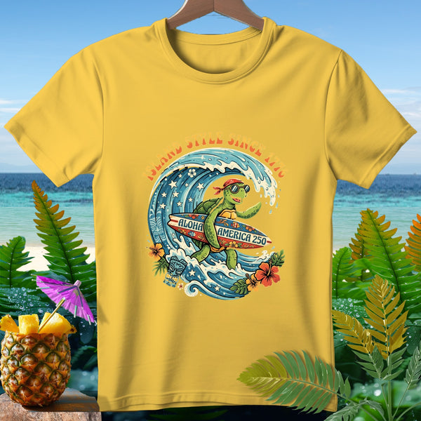 Yellow t-shirt with a turtle surfing on a wave, "Island Style Since 1976" and "Aloha America 250".