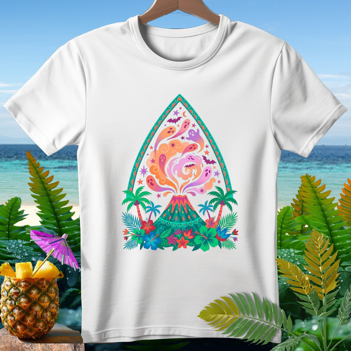 White t-shirt with a colorful design of a volcano, ghosts, and tropical foliage.