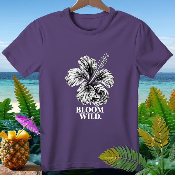 Purple t-shirt with white hibiscus, wave, and text "BLOOM WILD."