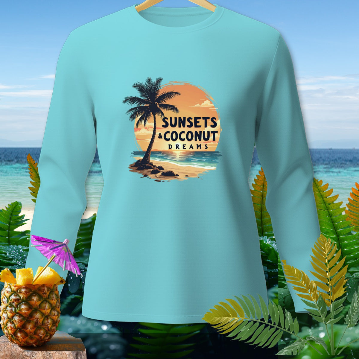 Light blue long sleeve shirt with "Sunsets & Coconut Dreams" tropical sunset graphic.