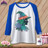White baseball tee with witch silhouette adorned with tropical leaves and flowers.