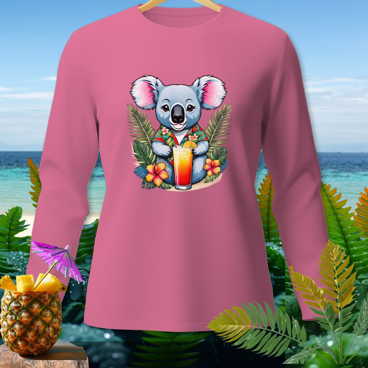 Pink long-sleeve shirt with cartoon koala holding a tropical drink and surrounded by flowers.